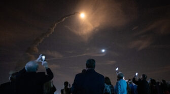 smoke trail of artemis rocket launch into florida's night sky